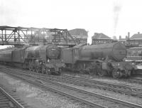 An up ECML express rushes south through Doncaster station on 29 July 1961 hauled by A2 Pacific no 60524 <I>Herringbone</I>. Standing at the platform is K3 2-6-0 no 61965 which has recently arrived with the 2.40pm from Hull.<br><br>[K A Gray 29/07/1961]