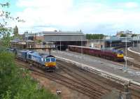 Looking north over Perth station on 30 May 2011. WCR 57001 with <I>'The Royal Scotsman'</i> at platform 3 is by-passed by 66414 <I>'James the Engine'</I> running through platform 7 with a Stobart container train.<br><br>[Brian Forbes 30/05/2011]