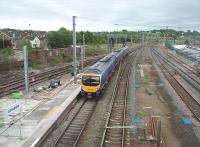 <I>Pendalongo</I> platform extensions are being constructed at various WCML stations to accommodate the planned 11 coach trains. This is the extension to Platform 4 on the Up line at Lancaster, seen here on 15th June 2011 as TPE 185109 leaves on a service for Preston. [See image 20266]<br><br>[Mark Bartlett 15/06/2011]