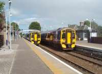 Services crossing at Nairn on the afternoon of 300611. 158702 on the left is heading for Inverness while 158719 is bound for Aberdeen. View east towards Forres.<br><br>[Mark Bartlett 30/06/2011]