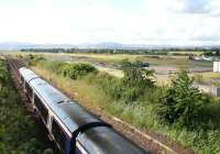 A Dundee - Edinburgh service runs along the eastern perimeter of Edinburgh Airport near the site of Turnhouse station (closed September 1930) on a July afternoon in 2007. The horizon to the south is formed by the Pentland Hills.<br><br>[John Furnevel 08/07/2007]