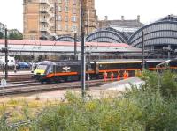 At first glance it could be mistaken for a guard of honour in corporate colours waving a Grand Central service away from York station. It is in fact a Network Rail PW team standing clear as the 11.23 Kings Cross - Sunderland service restarts from York on 29 June 2011.<br><br>[John Furnevel 29/06/2011]