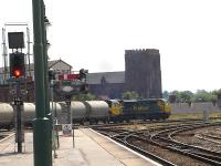Freightliner 70005 heads south out of Shrewsbury shortly after mid-day on 14 July with the normally class 66 rostered loaded Lafarge cement working from Hope to Aberthaw.<br><br>[David Pesterfield 14/07/2011]