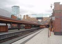 The reopened and restored bay platforms at Moor Street station, looking towards the buffers in June 2011. The attention to period detail throughout the renovation of this busy commuter station is striking. The <I>Bull Ring</I> tower in the background overlooks the south end of Birmingham New Street and illustrates how close to each other the two stations are situated. [See image 48181] for the same scene ten years earlier.<br><br>[Mark Bartlett 08/06/2011]