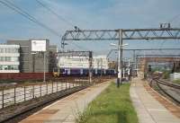 Looking across to the LNWR lines from Ardwick's deserted platforms, situated on the old Great Central route. Northern EMU 323237 is approaching Ardwick junction (where the two companies met) on a suburban service for Manchester Piccadilly. <br><br>[Mark Bartlett 03/08/2011]