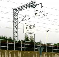 The new summit-board near Forrestfield on the Airdrie-Bathgate route named after the late Derek Holmes. Born in Dundee in 1959, Derek began his railway career as a signalman in the Dundee area. At the point of his untimely death in January 2010 he held the position of Production Director with Network Rail, as well as being chairman of the Institution of Railway Operators.<br>
<br><br>[John Furnevel 19/09/2011]