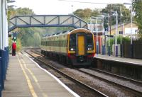 A South West Trains Waterloo to Exeter 6 car DMU with 159011 leading and 159014 at the rear flies westward through Overton station west of Basingstoke just after midday on 23 September 2011.<br>
<br><br>[John McIntyre 23/09/2011]