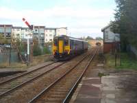 The semaphores at Prescot, which include this curious little bracket starter, will not survive the forthcoming electrification. 156472 heads towards St. Helens on a stopping service from Lime St to Wigan. The modern flats occupy old railway land.<br><br>[Mark Bartlett 13/10/2011]