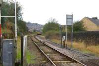 A Blackpool South to Colne service approaches Chaffers Crossing east of Nelson station on 21 October 2011. The driver will bring the train to a stand with the cab window next to the board on the right and pull the cord to initiate the closing of the barriers [see image 17268].<br>
<br><br>[John McIntyre 21/10/2011]