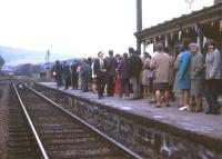 <I>Here comes the train... and only 13 years late!</I> An expectant crowd spots the class 24-hauled service from Inverness as it approaches Alness for the official reopening ceremony on 7 May 1973. The station had closed in 1960 when pre-Beeching cuts eliminated a swathe of wayside stations on the Far North line.<br><br>[David Spaven 07/05/1973]