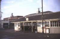 Waiting for the Gravesend Ferry at Tilbury Riverside in December 1984. The station clock stands on the horizon right of centre with the Port of London Authority building to the left. The terminus lost its passenger service in November 1992 and the station is now used as an arts centre and car park. Connection with the ferry is now provided by a shuttle bus service from Tilbury Town station. [See image 37969] <br><br>[Ian Dinmore /12/1984]