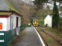 158820 leaves Penhelig after picking up a passenger and heads towards the east side tunnel on the 13.26 service to Machynlleth. For a small halt there is a substantial wooden waiting room on the platform. <br><br>[David Pesterfield 06/12/2011]