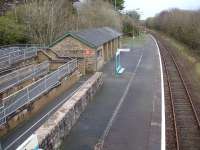 View east over Penychain Station in December 2011, showing the extensive ramped access and the large barn type waiting room. This station is adjacent to the Haven Holidays (formerly Butlins) holiday camp and in its heyday would have catered for hundreds of families arriving and departing on summer Saturdays.<br><br>[David Pesterfield 08/12/2011]