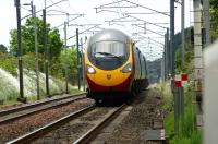 With a slight heat shimmer surrounding it, a northbound Virgin Pendolino races along the straight approaching Bolton-le-Sands LC on 19 June 2010.<br><br>[John McIntyre 19/06/2010]