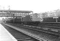 The sprawl that was Kensington Olympia in June 1969, with Type 3 'Crompton' no D6570 taking a freight south on one of the through roads towards Clapham Junction. At that time various bays and sidings still stood on both sides of the running lines, together with significant areas of unused former railway land, but not for very much longer [see image 5189].<br><br>[John Furnevel 05/06/1969]