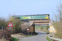 Scene at Longcot on the eastern edge of Swindon on 15 March with Freightliner 66567 passing on an eastbound container train.<br><br>[Peter Todd 15/03/2012]