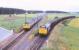 Scene at Alves Junction, photographed from the A96 road bridge on 3 August 1979. 25234 is held with a freight off the Hopeman branch as a passing Inverness - Aberdeen DMU runs through the junction.<br><br>[Peter Todd 03/08/1979]