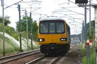 A Northern service from Heysham Port to Leeds on 19 June 2010 approaching the level crossing at Bolton-le-Sands.<br><br>[John McIntyre 19/06/2010]