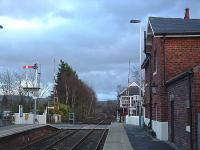 A 2004 view south over the level crossing at Nunthorpe showing the station building, signalbox, level crossing and the south end of the passing loop.<br><br>[Ewan Crawford 20/03/2004]