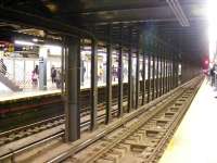 A rather quiet 42nd Street subway station on 26 February 2012. Signage for lines N R and Q can be seen to the left. In the distance a recently departed service enters the tunnel. <br><br>[Colin Harkins 26/02/2012]
