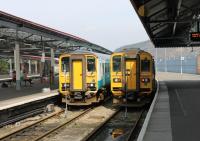 Twins at Swansea. Contrary to appearances these are two identical Sprinter <I>Bubble Cars</I>. However, 153320 on the left is seen from the original front end whereas 153303 on the right shows the converted former inner end from its days as part of a two car unit. The two units were waiting to form westbound trains.<br><br>[Mark Bartlett 23/03/2012]