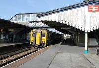 The 0730hrs Saturday service from Pembroke Dock to Swansea, formed by ATW Sprinter 150281, calls at Llanelli. Much of this station's old infrastructure survives including the large awnings and footbridge seen here. <br><br>[Mark Bartlett 24/03/2012]
