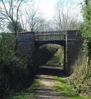 Cast-iron overbridge at Lodge of Kelton in April 2012 looking towards Kirkcudbright - now bypassed by a loop in the road over the infilled cutting. <br><br>[Colin Miller 01/04/2012]