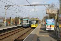 A contrast between a twenty year old 1000 series tram and its 3000 series successor at Timperley in March 2012. Under an original pre-war gantry 3002 runs in on an Altrincham bound service while 1022 heads for Piccadilly. Some of the 10xx trams are to be withdrawn as a source of spares to keep sister units running as they are proving somewhat troublesome in later life.<br><br>[Mark Bartlett 08/03/2012]