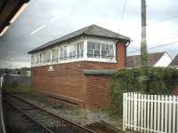 The large Pembrey signal box sited on the north side of the West Wales main line to the east of Pembrey & Burry Port station. Photographed from a passing west bound train on 18 April 2012. <br><br>[David Pesterfield 18/04/2012]
