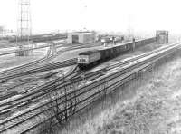 A Brush Type 4 locomotive takes an up freight out of a pre-electrification Kingmoor Yard in April 1971. Note the surviving water tank in the right middle distance.<br><br>[John Furnevel 02/04/1971]