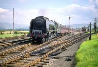 A WCML service calls at Symington on the first day of August 1959. The driver of Polmadie Coronation Pacific no 46230 <I>Duchess of Buccleuch</I> looks back along the platform prior to resuming the journey north.<br><br>[A Snapper (Courtesy Bruce McCartney) 01/08/1959]