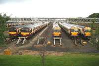 Trains stabled in the yard at Yoker Depot, Glasgow, on a wet and windswept Sunday morning in September 2007. View is west towards Dumbarton and Helensburgh, with the main line running past on the right of the picture.<br><br>[John Furnevel 23/09/2007]