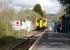 150284 with the 12.07 service on to Swansea runs over the level crossing into Ammanford Station on 11 April to pick up a group of passengers. <br><br>[David Pesterfield 11/04/2012]