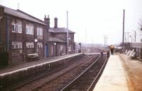 Electrification work underway at Shepreth to the south west of Cambridge in the 1980s. View is south west over Station Road level crossing looking towards Hitchin. Electrification of the Kings Cross - Cambridge line was completed in 1988. <br><br>[Ian Dinmore //]