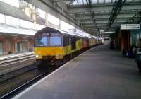 The garish colours and modern design of Colas Rail 66846 (hauling empty timber wagons South) contrasts with the old-fashioned architecture and muted colours of Shrewsbury station on 20 June 2012.<br><br>[Ken Strachan 20/06/2012]
