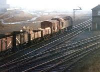 As the sun begins to break through the fog a mixed freight trundles south past Dentonholme North box on the Carlisle goods lines in 1969. Meantime, on the other side of the former Viaduct Yard, with track now lifted, an up express is about to enter Citadel station.<br><br>[John Furnevel 17/12/1969]