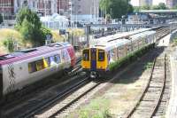 Scene at Kensington Olympia on the West London Line on 20 July 2005 as a Virgin CrossCountry Voyager arrives with a Brighton - Birmingham service. On the right, one of the Silverlink dual voltage 313 units is pulling away from the southbound platform with a Willesden Junction - Clapham Junction train.<br><br>[John Furnevel 20/07/2005]