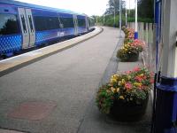 <I>'Forres in Bloom'</I> does a beautiful job in making the surviving platform at Forres extend a floral welcome for visitors to the Morayshire town. View east on 11 September 2012. <br><br>[John Yellowlees 11/09/2012]
