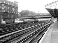 A BR InterCity 125 Bristol - Paddington service approaching its destination in 1982, seen from the platform of Royal Oak Metropolitan Line station. In the background one of the Western Region Express Parcels units is held under Lord Hill's Bridge awaiting clearance into Paddington parcels depot. [See image 36915] <br><br>[John Furnevel 22/01/1982]