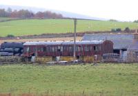 An old 9 compartment suburban coach has found further use on a farm near Torphins. Viewed from the B993 just south of the village on 19 October 2012. It would appear to have seen 'better days' and although missing quite a few bits and pieces has had two external lights fitted.<br><br>[John McIntyre 19/10/2012]