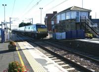 Coming out of the sun, the 09.30 ex-London Kings Cross runs north over Chathill level crossing on 8 October 2012. This train operates non-stop between Alnmouth (13.10) and Waverley (14.15). <br><br>[John Furnevel 08/10/2012]