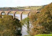 The colours of Autumn dominate in this view west along the Tweed from Berwick on 9 October 2012. The train crossing the Royal Border Bridge is the East Coast 09.00 Kings Cross - Edinburgh, which is slowing for the Berwick stop.<br><br>[John Furnevel 09/10/2012]