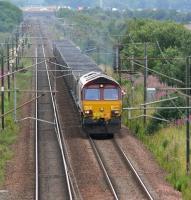 With heavy traffic on the M6 in the background, EWS 66076 approaches Gretna Junction from the south in August 2007 with coal empties. The train will take the G&SW route at the junction. <br><br>[John Furnevel 03/08/2007]