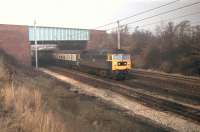 In weak winter sunshine 47448, with a Blackpool North to Manchester Victoria <I>Club Train,</I> slows for the crossovers at Euxton Junction in 1980. The train is passing under the M6 and will cross from the WCML Up Slow to take the Chorley and Bolton line. 47448, the former D1565, lasted in service until January 1991 when it was withdrawn from Crewe. It was cut up at Booths, Rotherham in 1996. <br><br>[Mark Bartlett 10/01/1980]