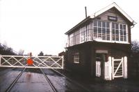 The signal box and level crossing at Saxilby, Lincolnshire, in January 1988. View north west towards Gainsborough with the top of Saxilby station building visible in the background [see image 41173]. <br><br>[Ian Dinmore /01/1988]