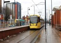 Metrolink tram 3014 waits briefly on a wet day at Eccles before returning to Piccadilly via the Salford Docks estate. Eccles tram terminus is only a short walk from the main line railway station. Pity about the litter at this town centre interchange.<br><br>[Mark Bartlett 28/12/2012]