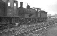 Class J21 0-6-0 no 65099 and BR 0-6-0DM no D2053 stand together in the sidings at the north end of Darlington shed awaiting admission to the nearby locomotive works. The photograph was taken in late 1961, shortly after 65099 had been withdrawn from Tyne Dock, having been identified as a potential preservation candidate. [See image 26302]<br><br>[K A Gray //1961]