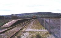 Basic facilities at Colne in August 1977 looking south west towards Nelson. The station was by then a terminus, with the through line to Skipton (behind the camera) having closed in 1970 [see image 38798].<br><br>[Ian Dinmore /08/1977]
