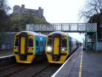 158818 and 158822 during extended stops at Harlech on 21 November, after bringing students to the local college. The trains are standing below Harlech Castle while awaiting their 08.25 departures to Birmingham International and Pwllheli respectively. <br><br>[David Pesterfield 21/11/2012]