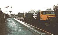 A PW train stands patiently in pouring rain at the north end of Appleby station in 1983. 47467 is awaiting permission to access the Eden Valley line.<br><br>[Ian Dinmore //1983]